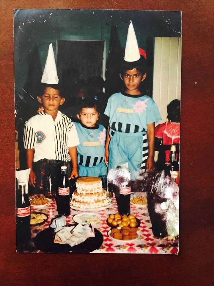 Children at a birthday celebration wearing paper party hats